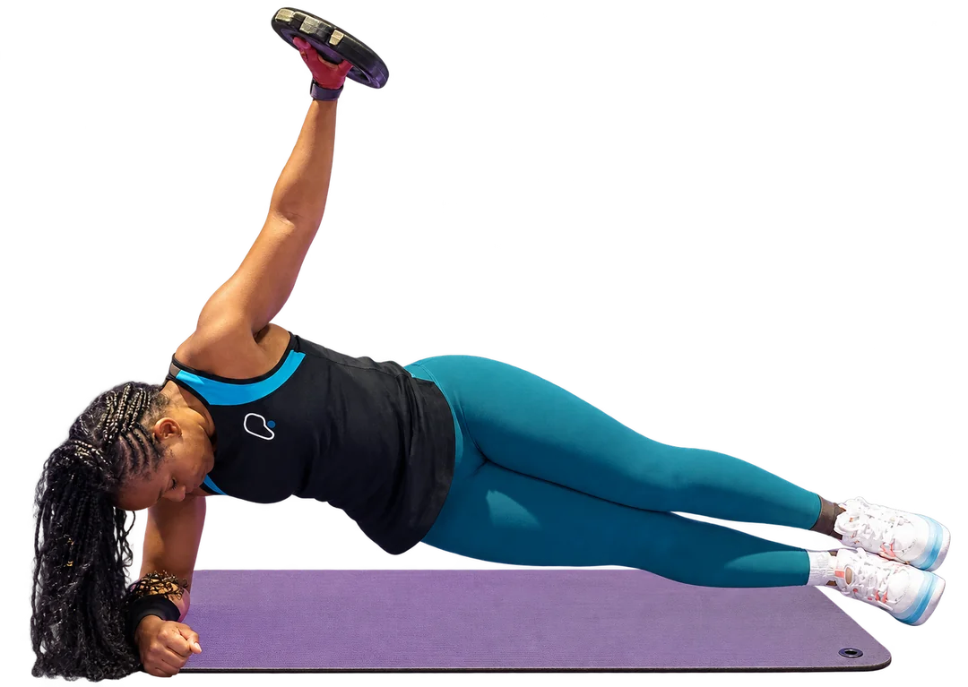 Tita holding a weight during a side plank